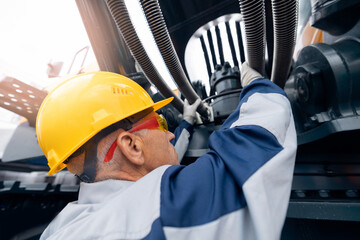 Hydraulic engineer doing safety check on new installation hoses of modern drilling industrial...