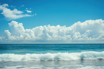 Obraz premium Blue sky with white clouds over blue ocean waves.