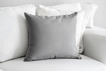 A mockup of a plain grey square pillow on a sofa