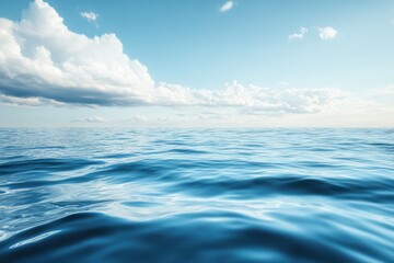 Obraz premium Calm blue sea with white clouds in the sky.