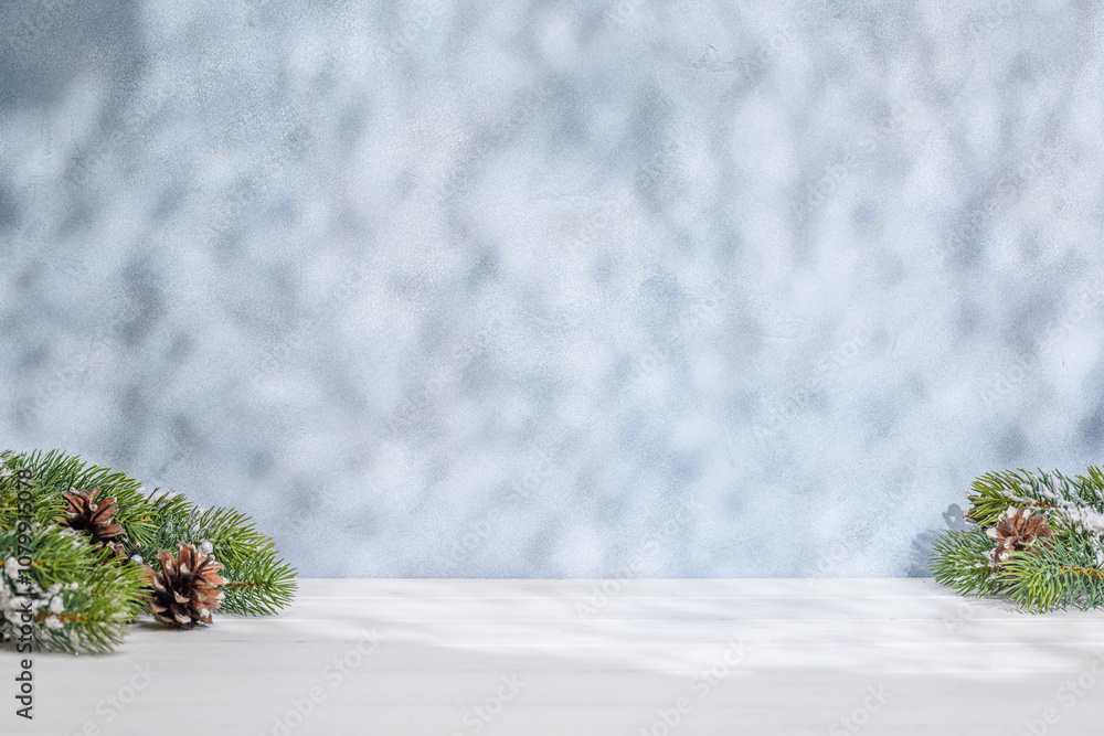 Aufkleber christmas template featuring snowy fir tree branches on a table with shadows and sun glares softly f