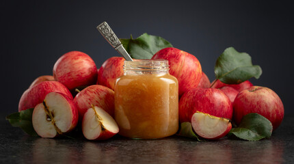 Apple jam and red fresh apples.