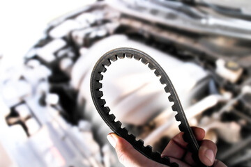 Close up of timing belt of automotive engine in a auto mechanic hand , Automotive spare parts...