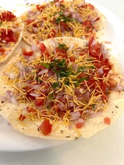 Close-Up of Indian Food Starter: Crispy Masala Papad with Garnish