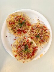 Close-Up of Indian Food Starter: Crispy Masala Papad with Garnish