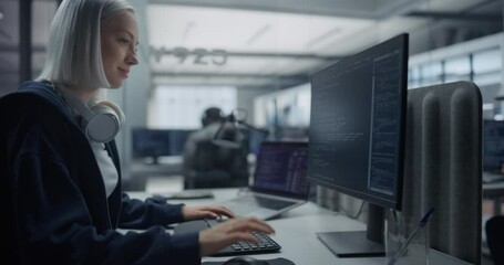 Female Software Developer Working on Computer in a Technological Laboratory, Writing Software Code. IT Programming Department Researching and Developing Commercial Internet Products. Zoom Out Footage - Powered by Adobe