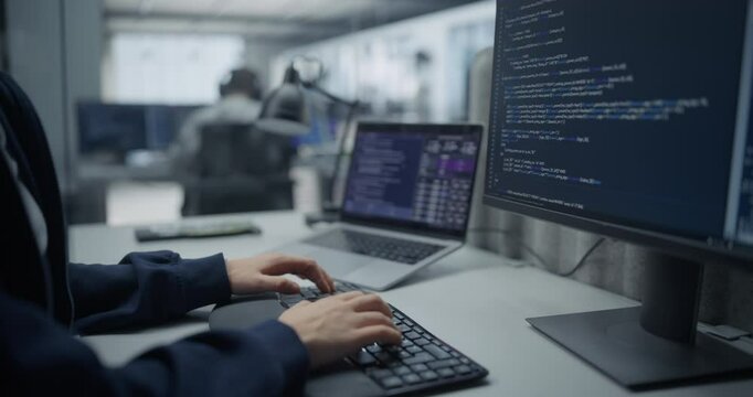 Close Up on Hands of an Anonymous Female Engineer Working on Desktop Computer in a Technological Corporate Agency. Specialist Writing Software Code for an Artificial Intelligence Training Model