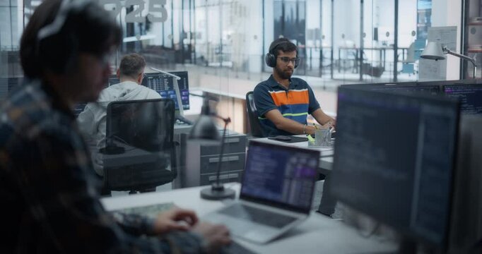 Diverse Male Developers Working on Machine Learning Frameworks and Code Software Back-End in a High-Tech Glass Office, Surrounded by Computer Screens with AI Algorithm Notes
