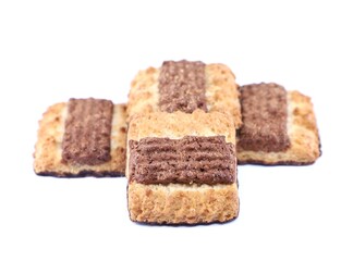 Shortbread cookies with large strip of chocolate cream on top. White background.