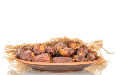 Dried sweet dates with homemade dishes isolated on white background, close-up.
