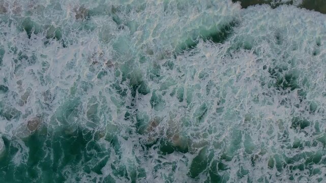 Top View Of Raging Sea Waves Splashing On The Ocean. aerial shot