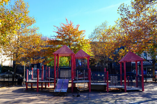 Red Kids Playground In Fall with Small Slide