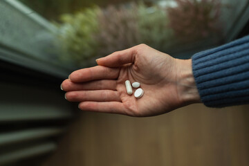 Woman's palm with daily dose of supplements