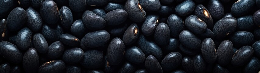 A close-up view of shiny black beans, perfect for culinary themes, healthy eating, or vegetarian recipes, showcasing their texture.