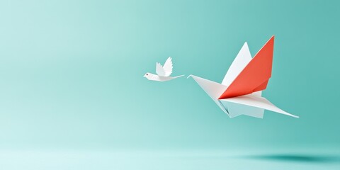 Two origami cranes, one in red and one in white, gracefully soar against a soft turquoise background, symbolizing peace and creativity.