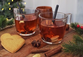 Traditional Swedish mulled wine with nuts and raisins in glass mugs.