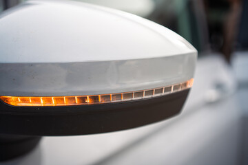 Modern Car Side Mirror with Turn Signal Indicator Illuminated for Safety on the Road