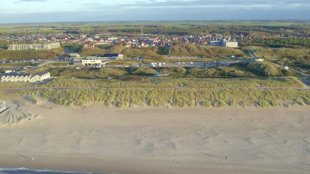 De Koog, Texel, The Netherlands, October 28, 2024, A breathtakingly stunning aerial perspective showcasing beautiful sandy dunes adjacent to a charming coastal town