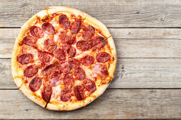 Pizza pepperoni fast food . Top view on rustic background