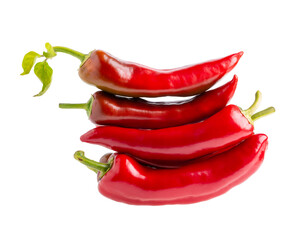Heap of red peppers with leaves isolated on white background. Close-up. Long sweet pepper Ramiro.
