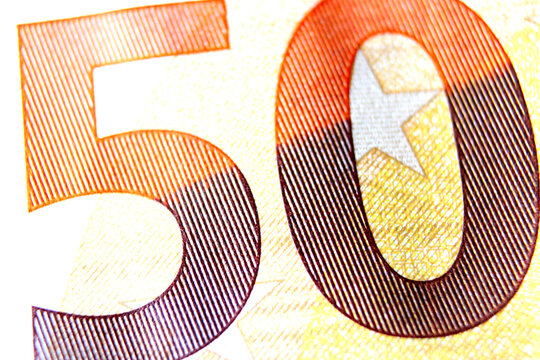 Close-up of a 50 euro banknote fragment on the obverse side, showing the denomination - number 50 . Macro photography.