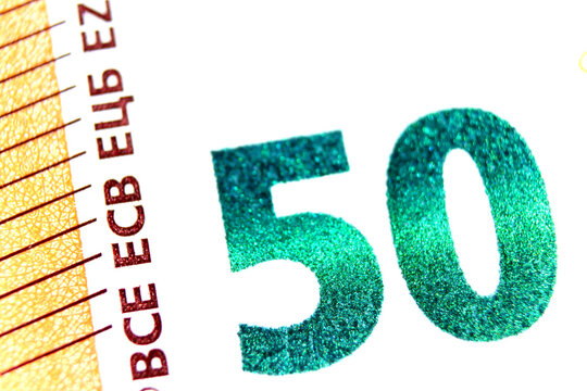 Close-up of a 50 euro banknote fragment showing the denomination - emerald number 50. Macro photography.