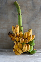 A closeup shot of a bunch of ripe bananas  on a wooden background with copy space