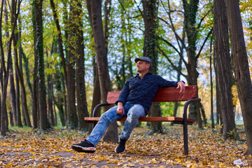 Fototapeta premium Mature man in the park on a bench