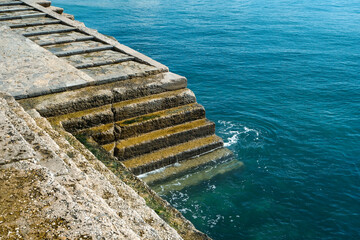 Stairs to crystal clear water.