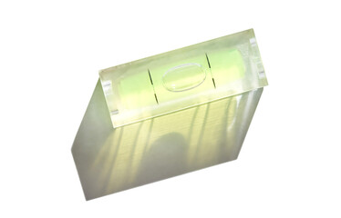 Precision tool with bubble level indicator casting shadow on white background.