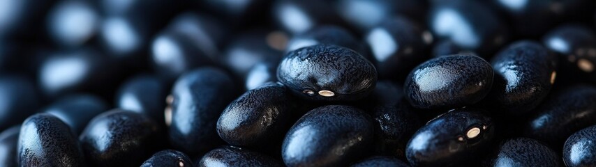 Close-up of shiny black beans, showcasing their smooth texture and rich color, perfect for culinary and dietary themes.
