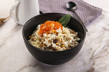 Curd with granola and orange jam