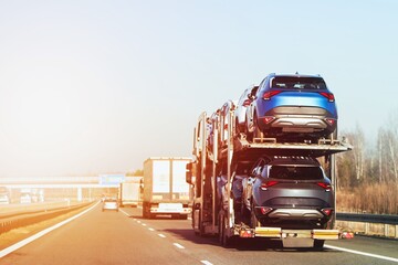 Truck carrying brand new SUVs on two-level trailer