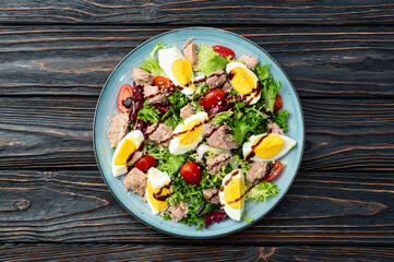 Canned Tuna salad with eggs and tomatoes photography . Top view