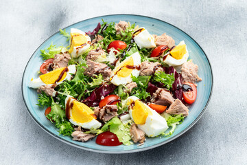 Canned Tuna salad with eggs and tomatoes photography . Top view