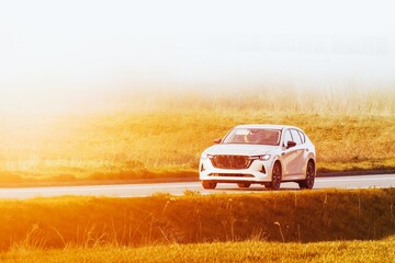Fototapeta premium Modern Family Car Driving on Country Road