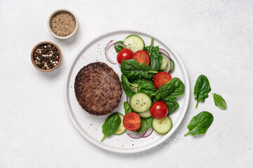 Grilled marbled beef with spinach salad on a plate on a white background with copy space. Protein lunch, healthy eating