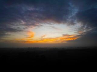 Dramatic sunset over misty landscape