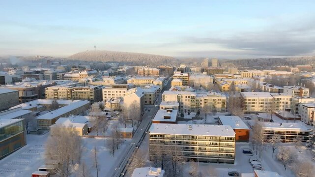 AERIAL: Kuopio city with the Puijo tower in the background, winter in Finland
