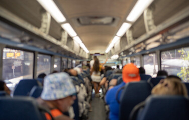 Tourists riding bus traveling on excursion, blurred interior public transportation