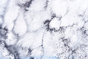 Abstract marble texture with black and white swirls and subtle hints of color.