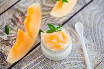 sweet homemade yogurt in a jar with pieces of ripe melon