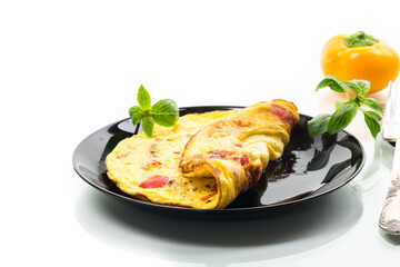 fried omelette with sweet pepper and vegetables in a plate, isolated on white background