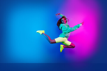 Full length photo of adorable lovely girl wear green hoodie having fun jumping high empty space...