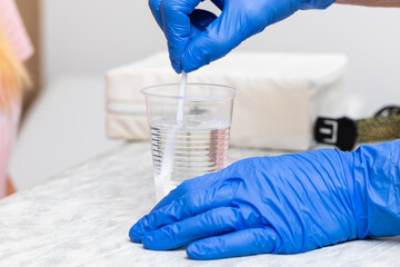 Healthcare Professional Preparing Glucose Solution for Tolerance Test