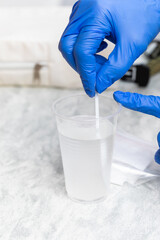 Healthcare Professional Preparing Glucose Solution for Tolerance Test