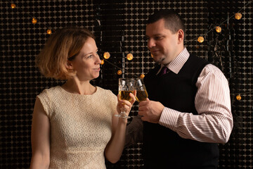 Couple Toasting Together at Celebration, celebrating an anniversary with champagne, smiling at each other in love