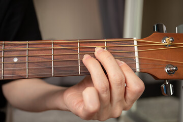 Hand Playing Acoustic Guitar Close-Up, guitarist practicing rock music, playful strumming strings