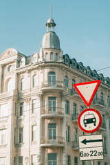 Road signs on the background of the former Savoy Hotel in Vinnytsia, Ukraine