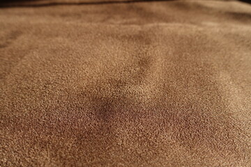 Close shot of chocolate brown faux suede polyester fabric